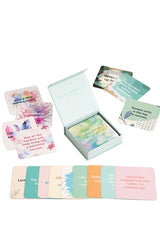 Set of colorful cards with inspirational messages in a box on a white background